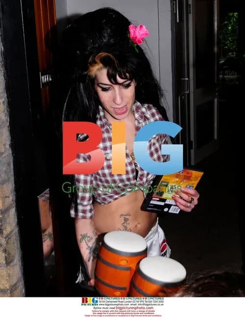 Amy Winehouse autographs bongo drums for boy