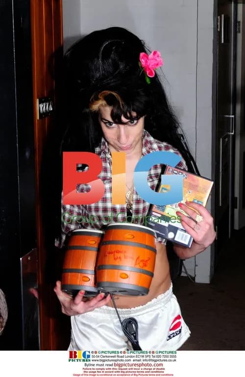 Singer Amy Winehouse autographs bongos
