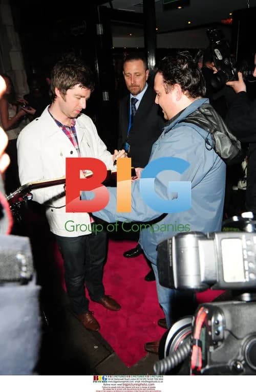 Noel Gallagher signs guitar at Percy and Reed launch