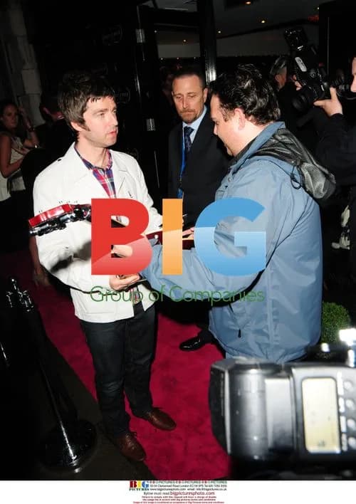 Noel Gallagher Signs Guitar at Percy and Reed Party