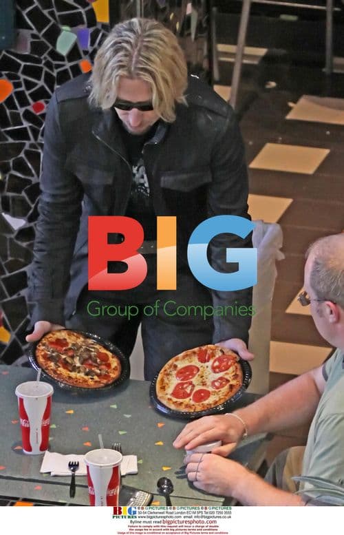 Chad Kroeger Enjoys Coke and Pizza at LAX