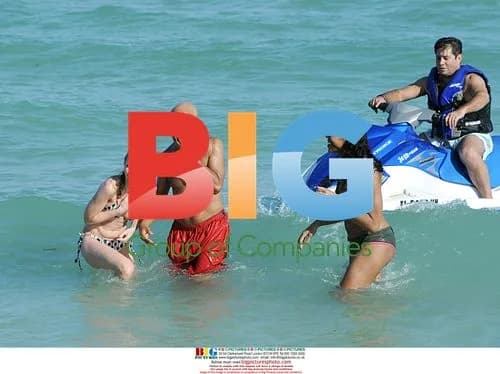 Russell Simmons Looks at Woman on Beach
