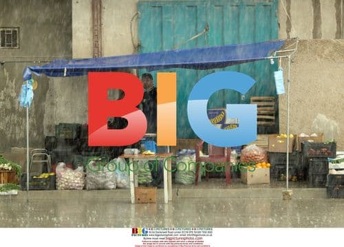 Iraqis selling fruit and veg in Baghdad rain
