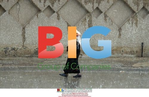 Iraqi Woman Walks in Baghdad Rain