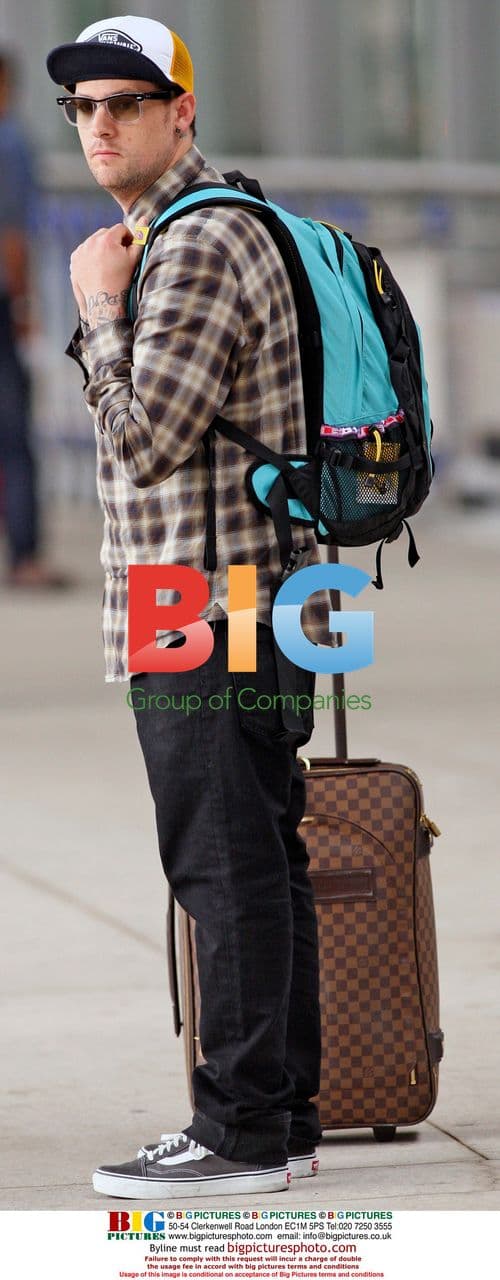 Joel Madden waits with luggage at LAX