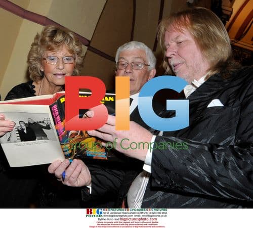 Rick Wakeman with book at golf club dinner