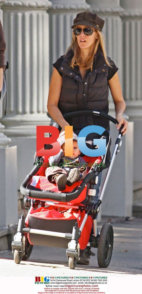 Kim Raver and son Leo walk in Soho