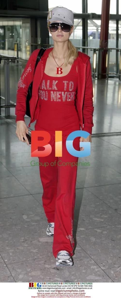 Paris Hilton Arrives at Heathrow in Red Tracksuit