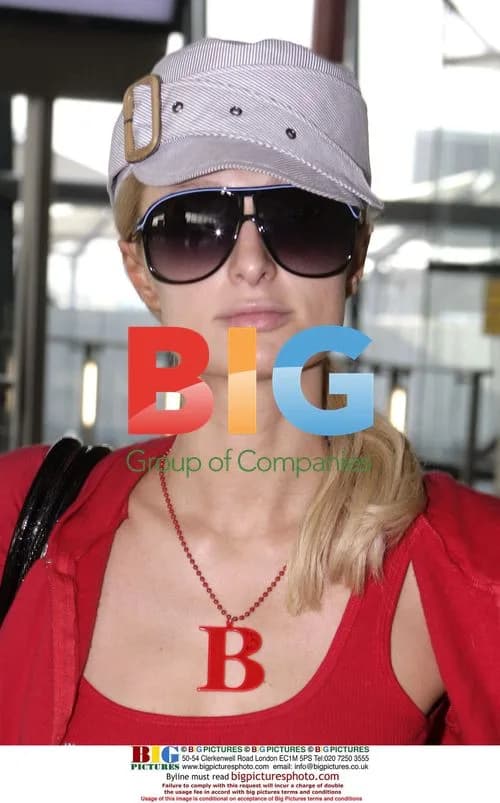 Paris Hilton Arrives at Heathrow in Red Tracksuit