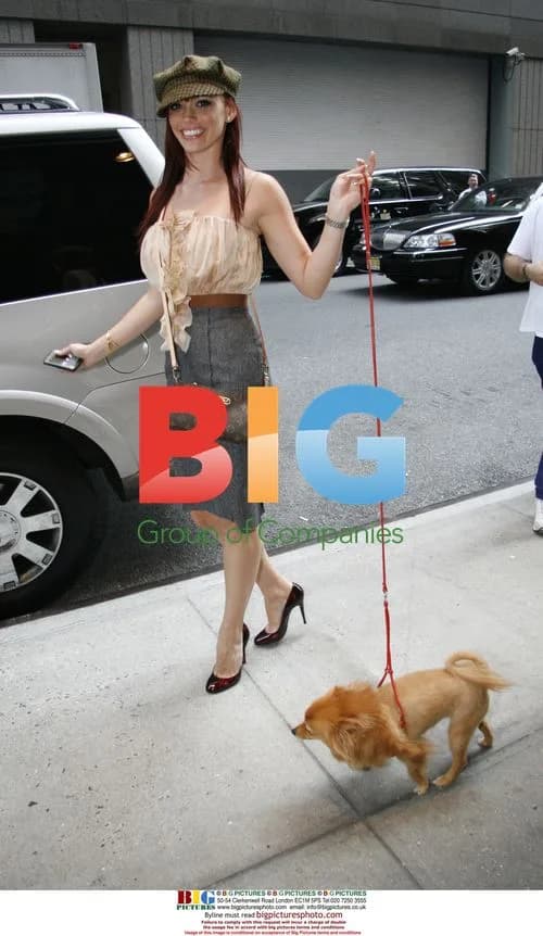 Jessica Sutta of the Pussycat Dolls walks her dog
