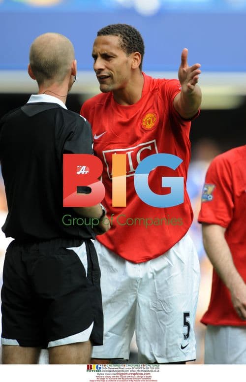 Rio Ferdinand argues with referee Mike Riley