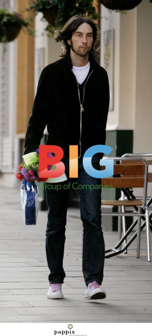 Primal Scream's Bobby Gillespie Holds Flowers in London