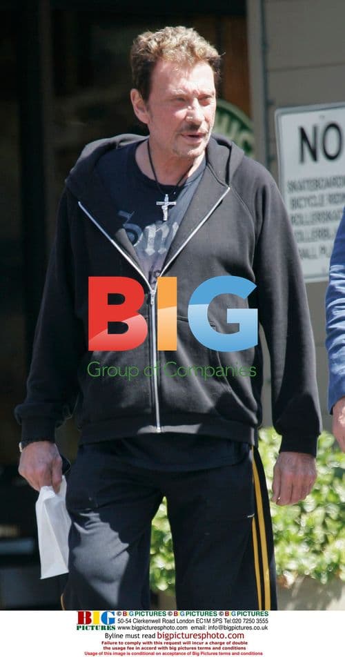 Johnny Hallyday leaves restaurant with friends