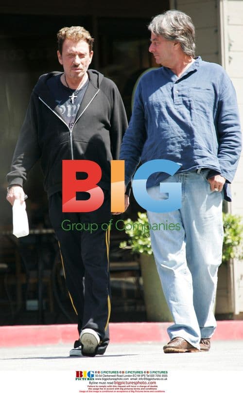 Johnny Hallyday carrying doggie bag