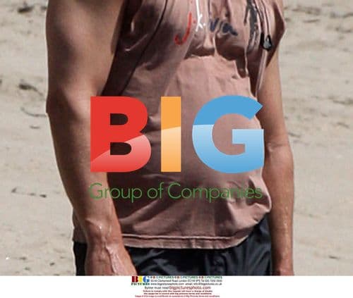 Matthew McConaughey playing fetch on the beach