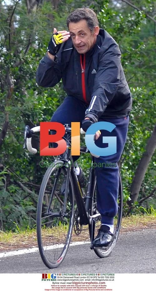 Nicolas Sarkozy bikes in rain