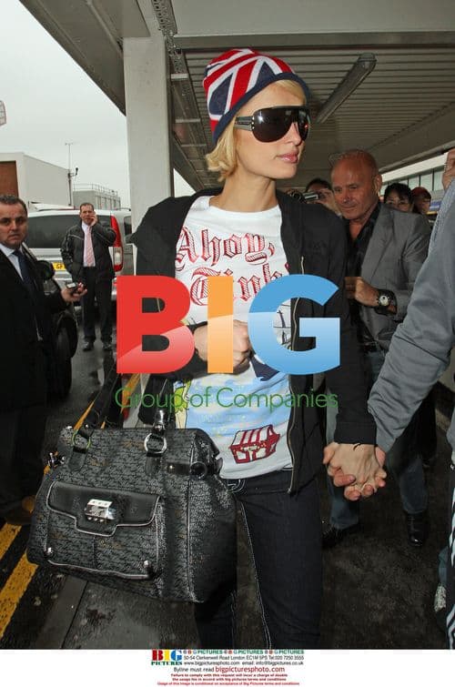 Paris Hilton and boyfriend arrive at Heathrow