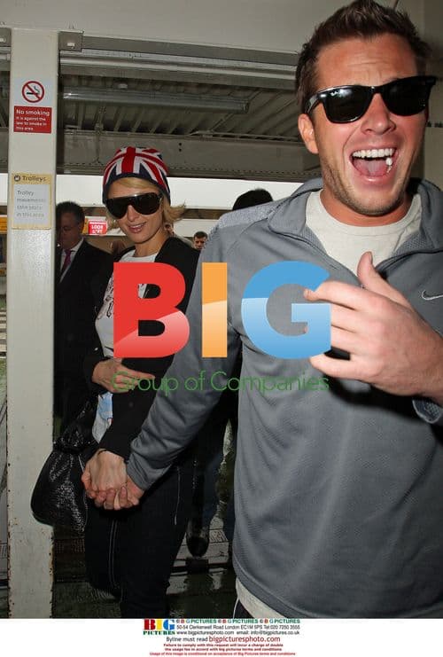 Paris Hilton and Doug Reinhardt arrive at Heathrow