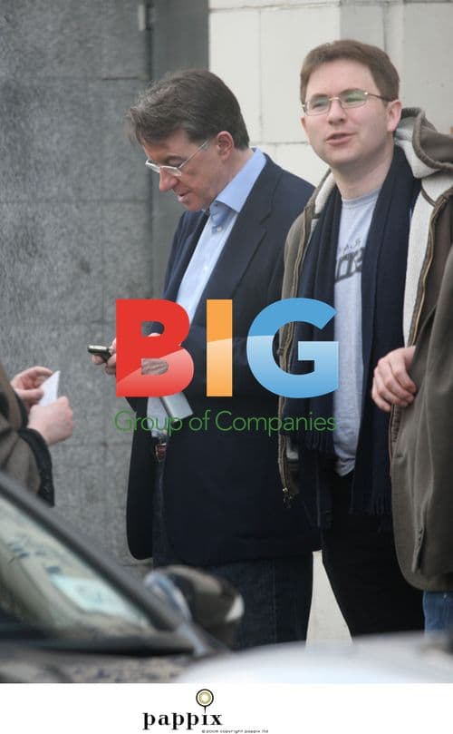 Peter Mandelson checks mobile with aide