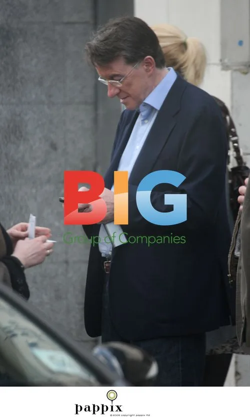 Mandelson checks phone with friends in Notting Hill