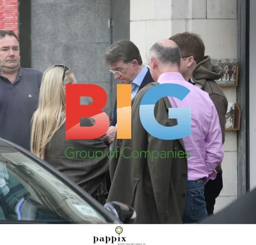 Peter Mandelson checks phone with aide