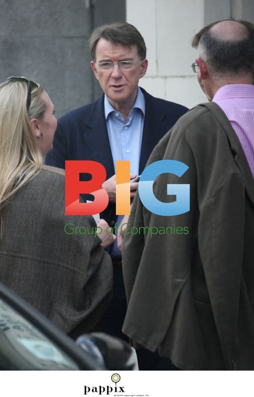 Peter Mandelson checks mobile before cinema