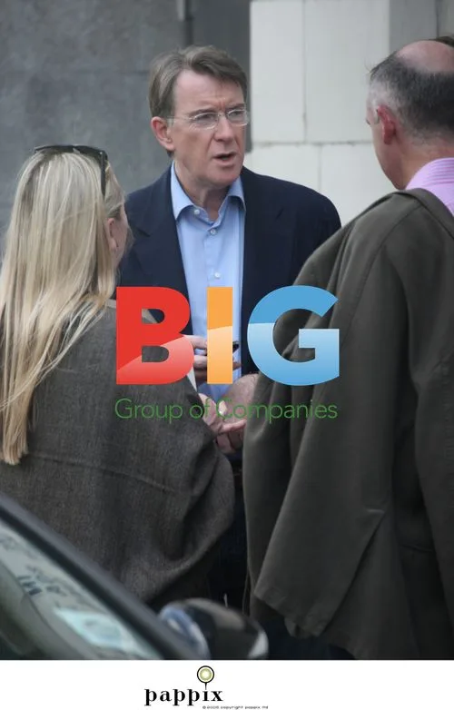 Peter Mandelson checks phone with friends