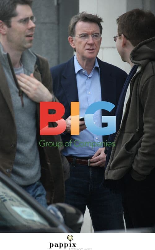 Peter Mandelson checks phone with aide