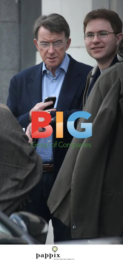 Peter Mandelson checks phone with aide in Notting Hill