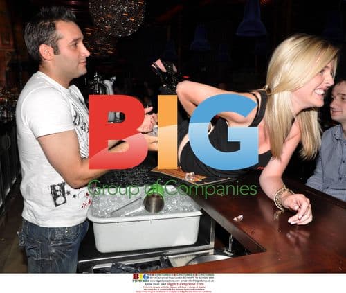 Singer Dane Bowers poses as cocktail waiter