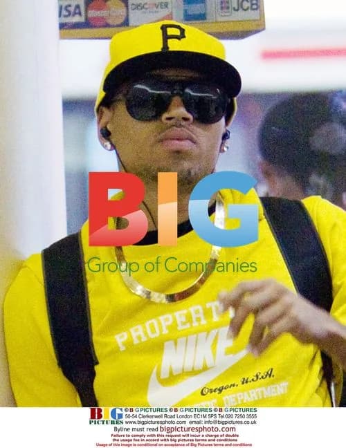Chris Brown Arrives at LAX in Yellow Outfit