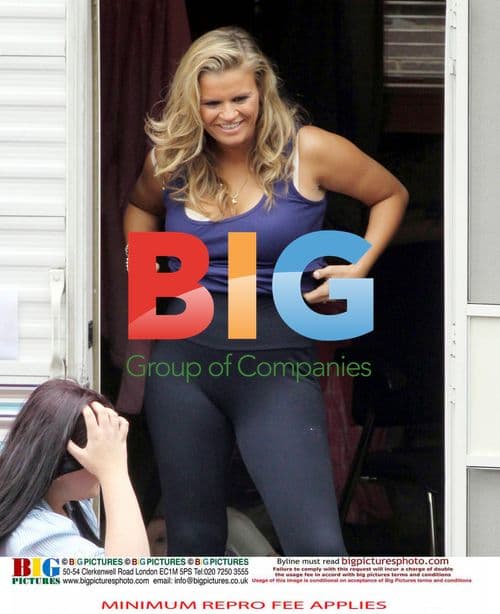 Kerry Katona adjusts undergarment on set