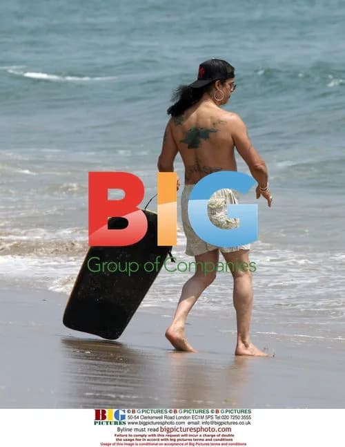 Slash from Guns N' Roses boogie boarding in Malibu