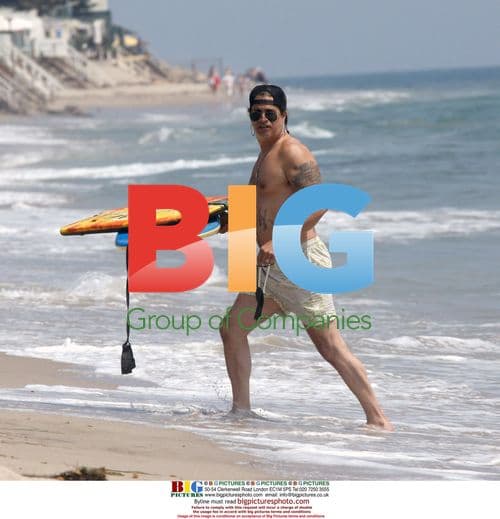 Slash from Guns N' Roses boogie boarding in Malibu