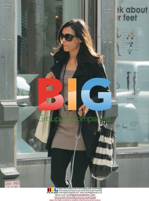 Famke Janssen walks dog in Soho