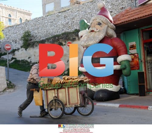 Palestinian vendor in Bethlehem with Santa