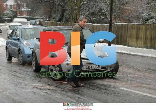 Public Volunteers Grit Icy Roads in North London