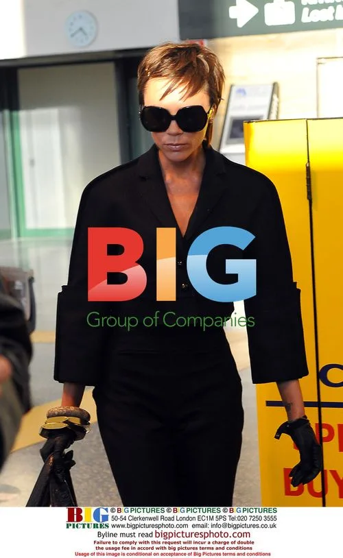 Victoria Beckham arrives in Milan with bodyguard