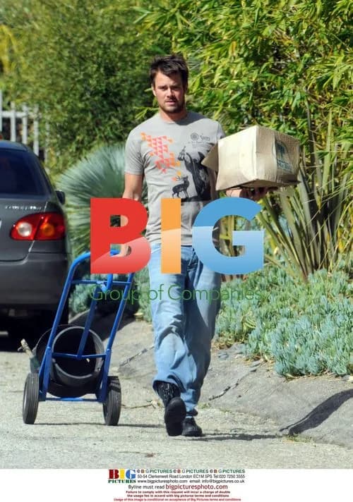 Josh Duhamel hauls planter outside home