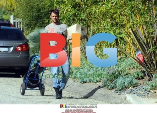 Josh Duhamel hauling planter outside home