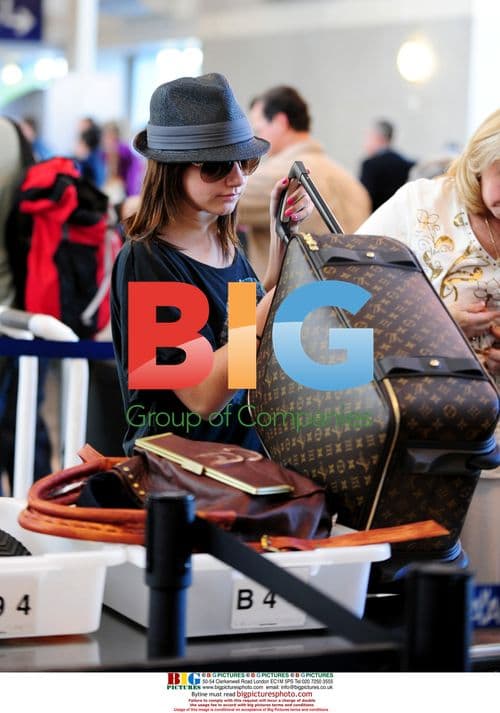 Ashley Tisdale at LAX with family