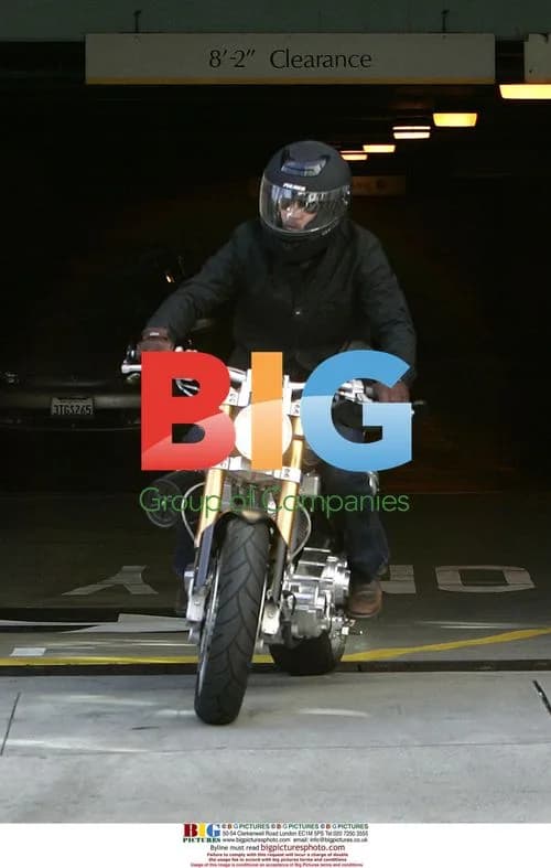 Brad Pitt leaves office on motorbike