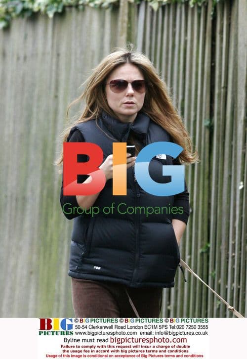 Geri Halliwell walking dog, texting in London