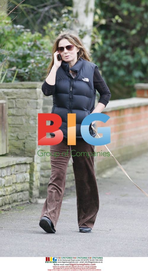 Geri Halliwell walking dog, talking on phone in London