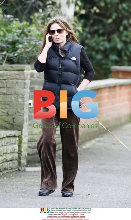 Singer Geri Halliwell walks dog, talks on phone in London