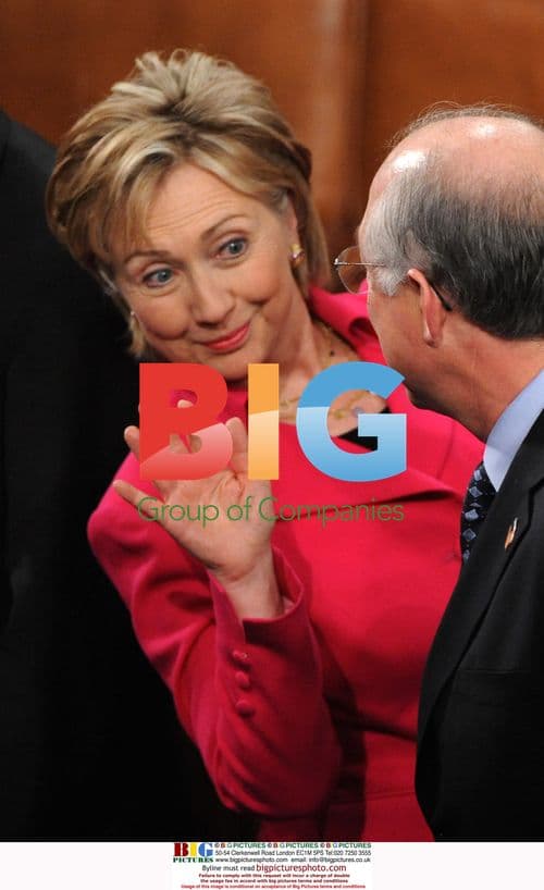 Hillary Clinton waves to friend before Obama speech