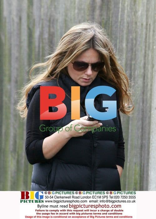 Geri Halliwell walking dog, texting in London