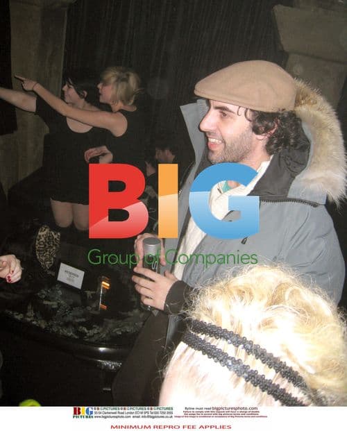 Sacha Baron Cohen hugging mystery woman