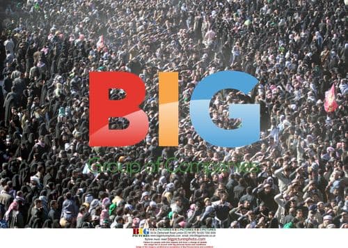 Shiite pilgrims wave flags during Ashura in Karbala