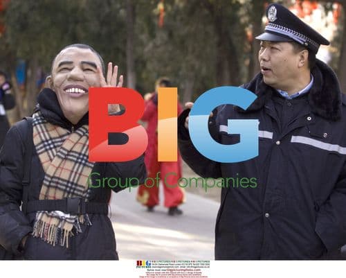 Chinese woman wears Obama mask at temple fair